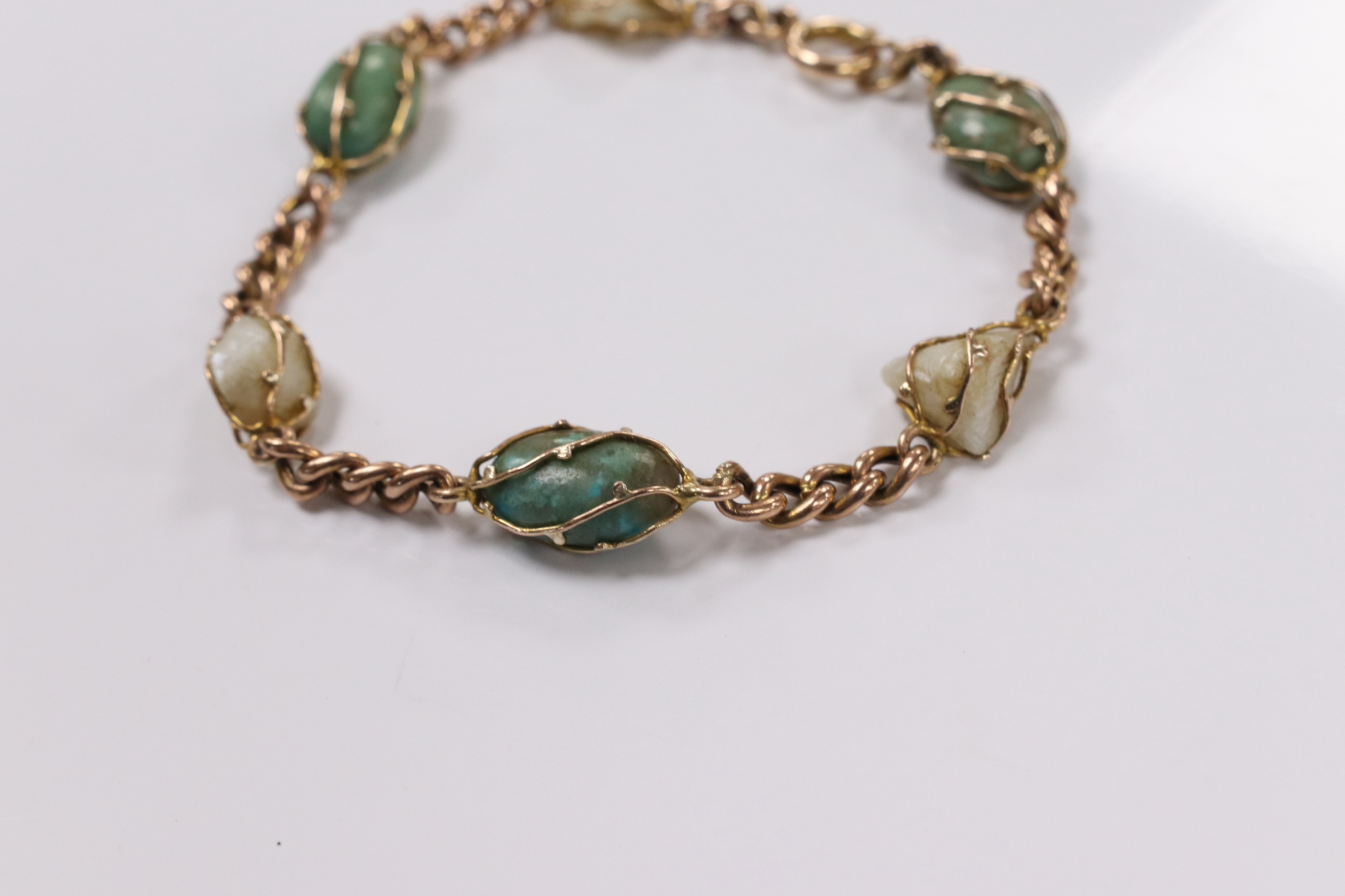 An early 20th century yellow metal, turquoise and baroque pearl set curb link bracelet, 18cm, gross weight 11.1 grams. Condition - fair